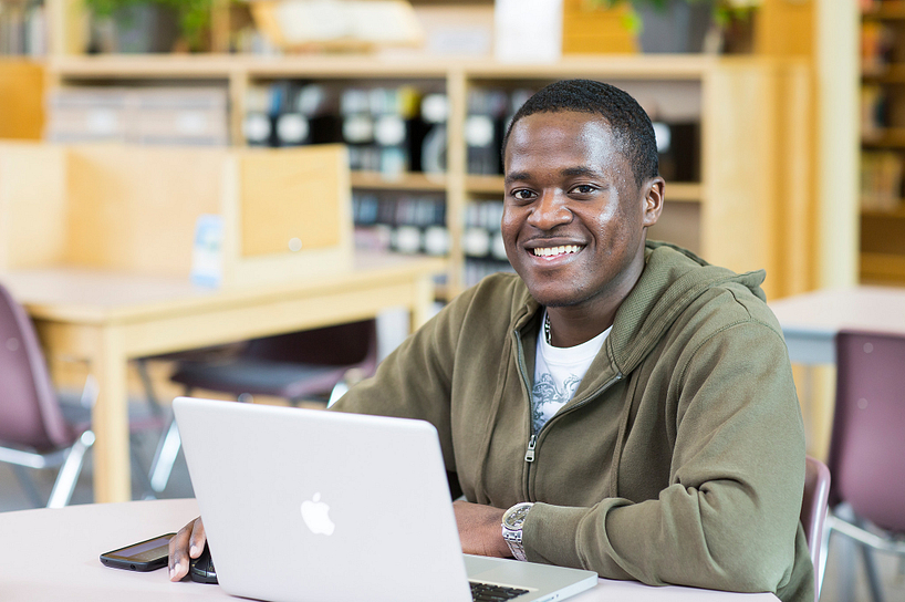 Male college student doing a skills assessment on his laptop