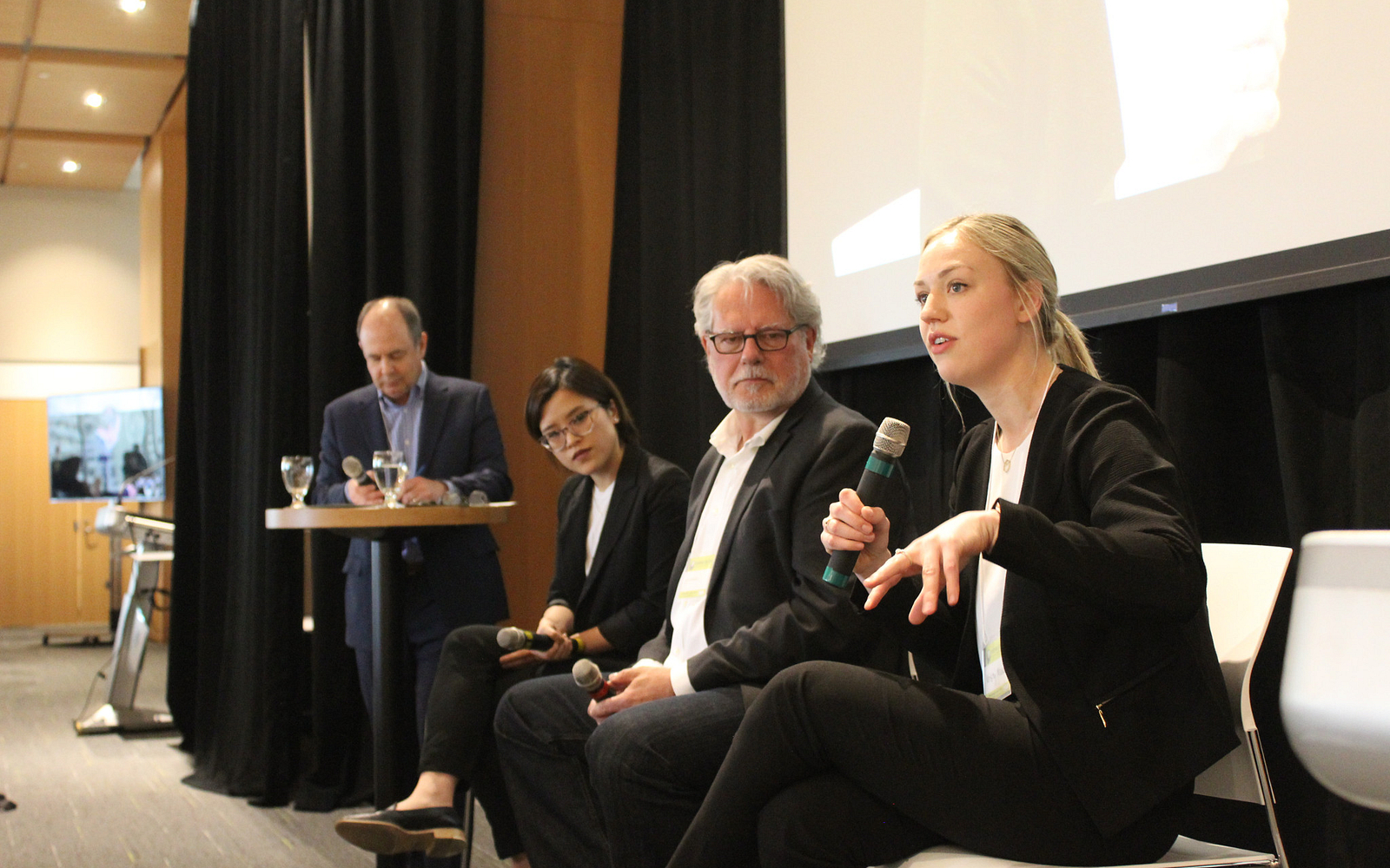Panelists speaking to an audience during RISES 2019