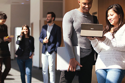 Centennial College students looking at a tablet screen whilst job searching