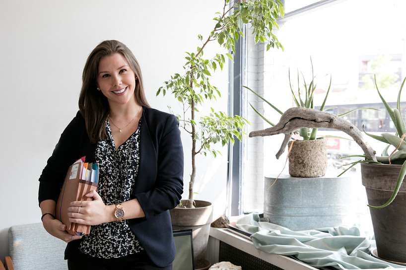 centennial college paralegal student smiling and standing in a law office