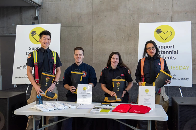 centennial college pre-service firefigther students smiling while taking donations for our giving tuesday event