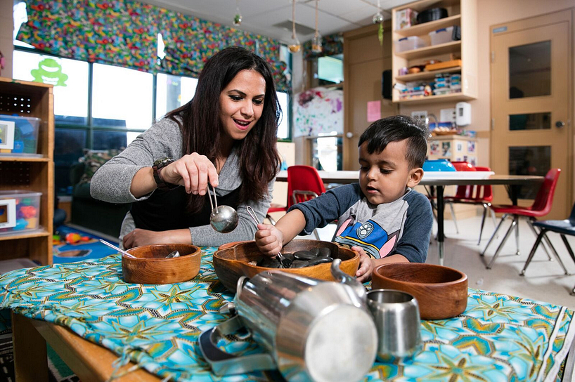 centennial college early childhood education student playing with a child in daycare