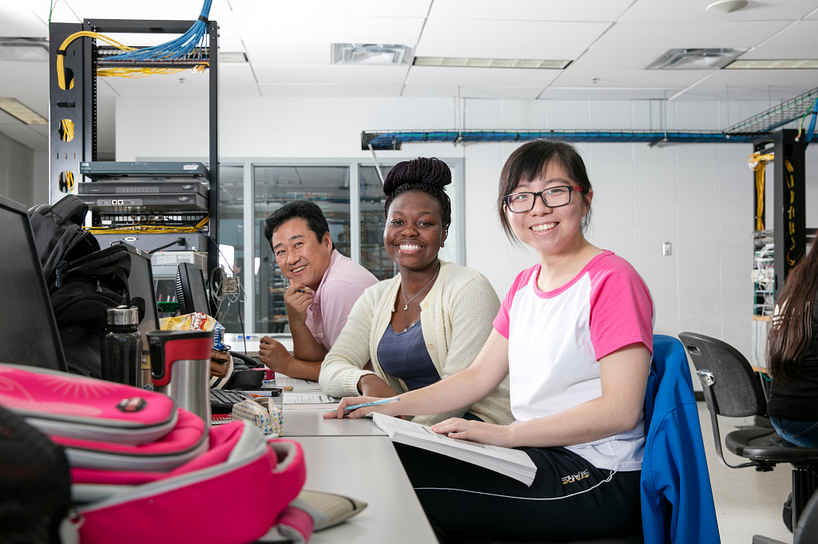 centennial college computer systems networking students in a lab smiling