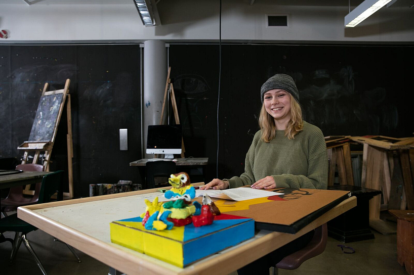 centennial college student smiling in a sculpting class