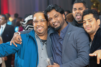 centennial college alumni smiling and posing on the dance floor at a homecoming event