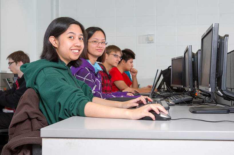 centennial college students working in a computer lab and smiling