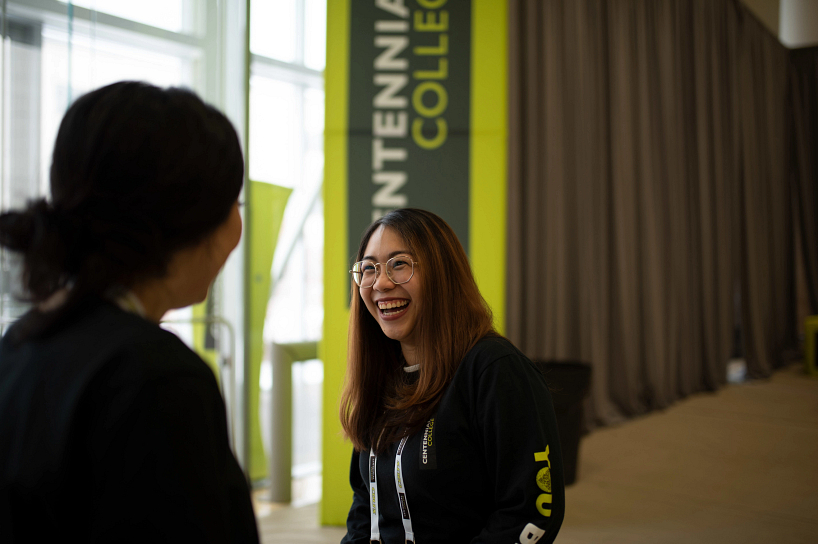 centennial college advisor laughing while talking with a future student