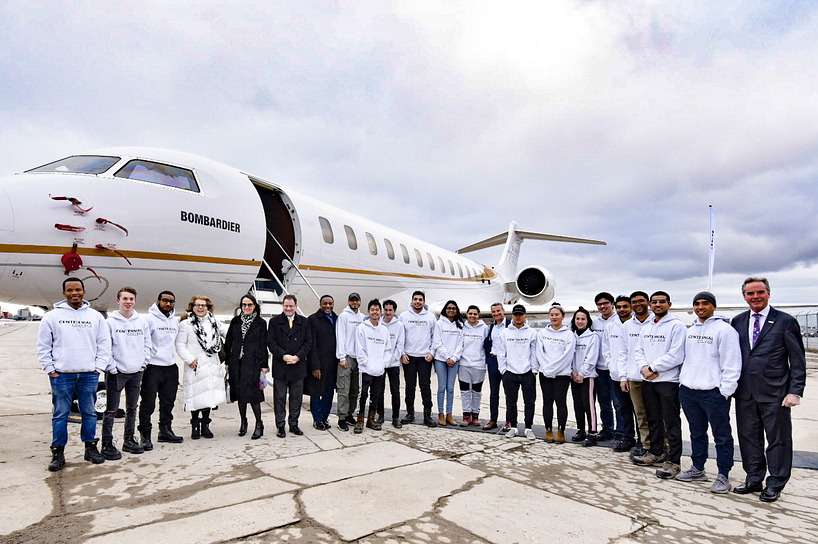 bombardier donated plane with centennial college students and community members standing in front of it
