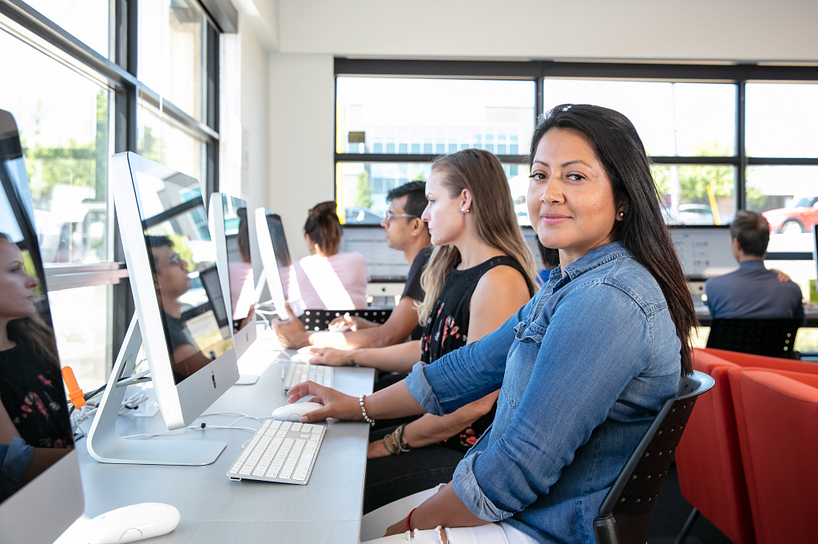 A student on a laptop looking for Centennial College services
