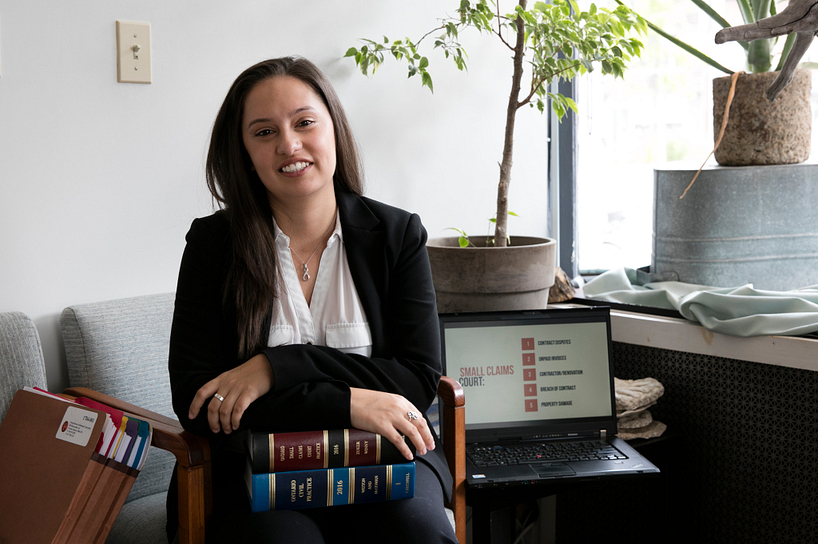 centennial college student smiling while working in a law office at a desk