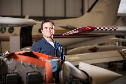 picture of an aviation technician aircraft maintenance student in a centennial college hangar by an airplane