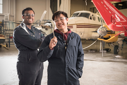 picture of aviation technician avionics maintenance students in a centennial college hangar by an airplane