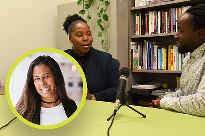 Three podcast speakers sitting behind a desk with microphones