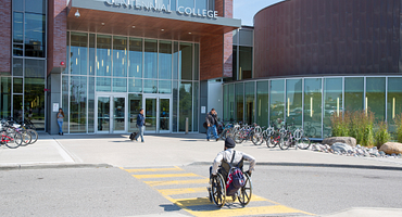 person in a wheelchair entering the library