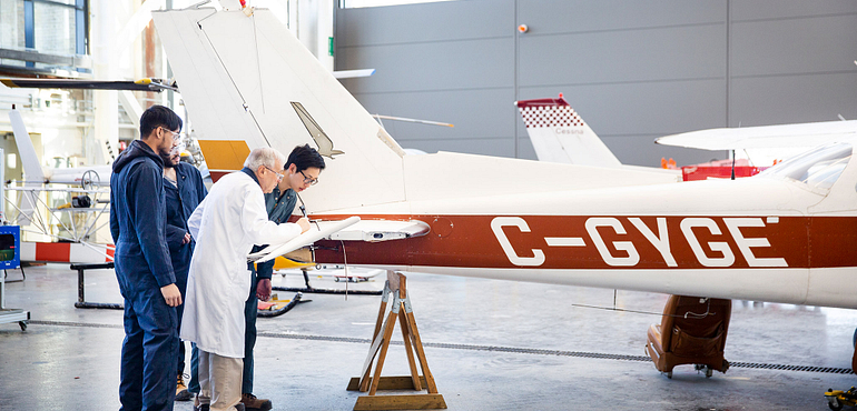 aviation students working on an airplane