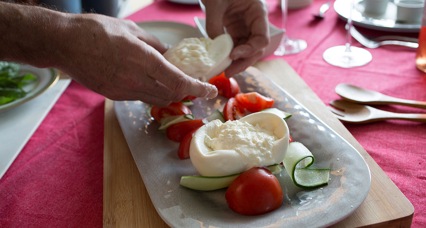 picture of a Centennial College chefs hands plating a plate for a photoshoot