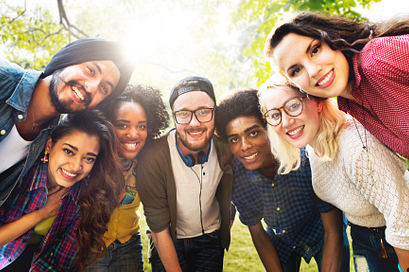 A group of diverse college students smiling outdoors
