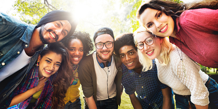 picture of the centennial college LGBTQ student social club in a group huddle smiling