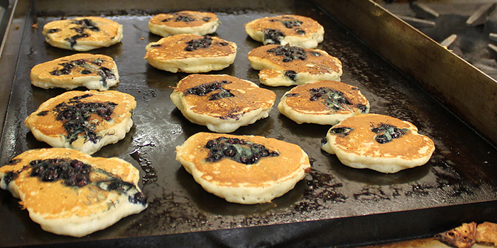 picture of blueberry pancakes cooking on stove
