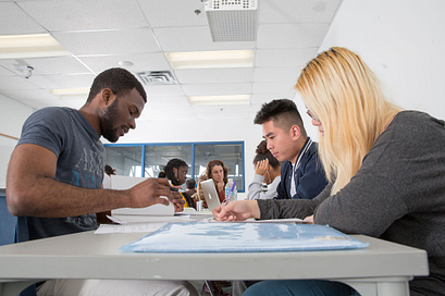 A group of students focused on their group project in the classroom