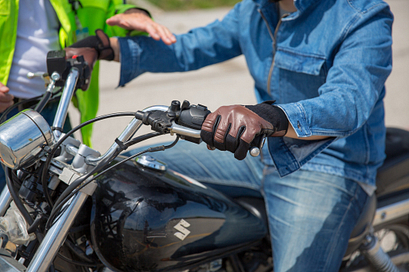 picture of a centennial college motorcycle rider training instructor teaching a student on a motorcycle