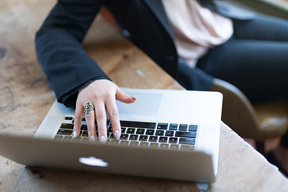A student on a laptop looking for Centennial College services