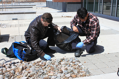 two volunteers picking up garbage