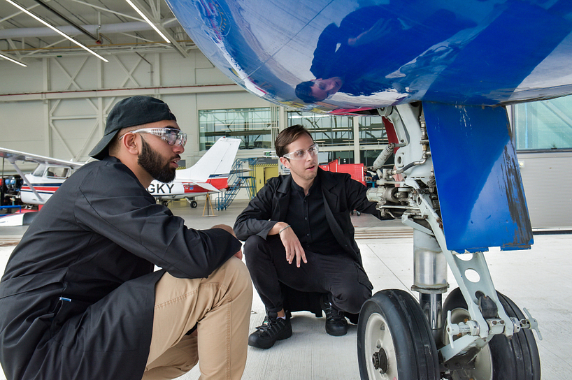 Aviation students examining a plane