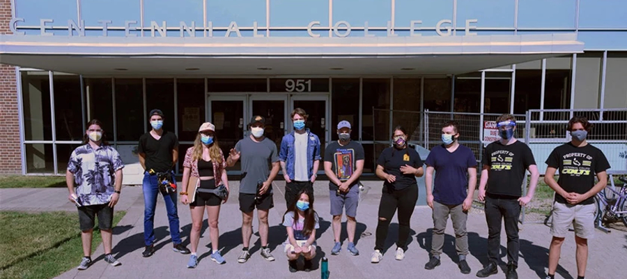 a group of centennial college broadcasting film, television, digital media and radio program students gathered for a group photo outside the story arts centre