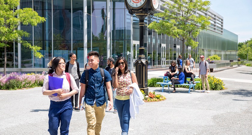 centennial college students walking and talking together in the progress campus courtyard