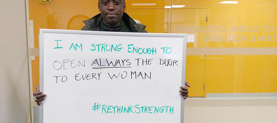 A Global Citizen Ambassador Lionel Kponyo holding a whiteboard with a positive message