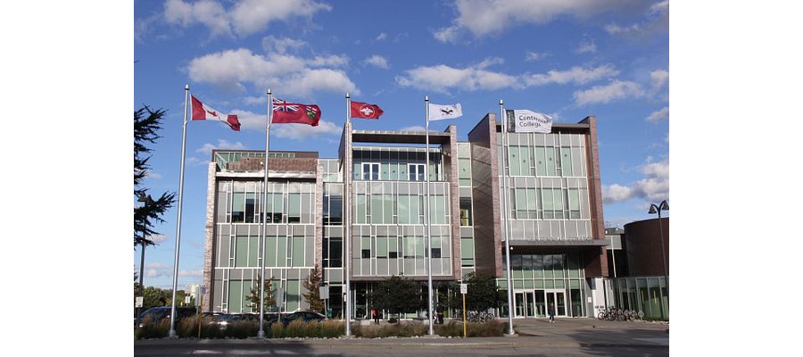 Centennial library building with Indigenous flags raised outside