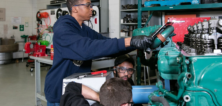 students working on an engine