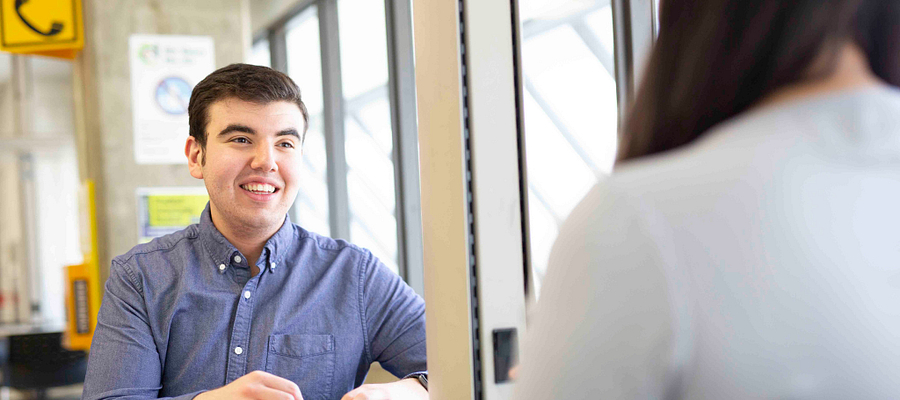 Two college students having a discussion at Progress campus
