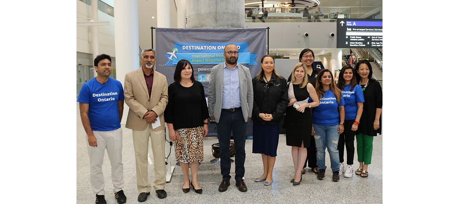 A group of people stand by the new kiosk at Toronto's Pearson Airport