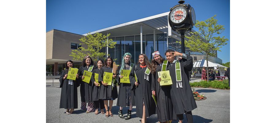 Happy Centennial graduates pose for a photo outside during convocation