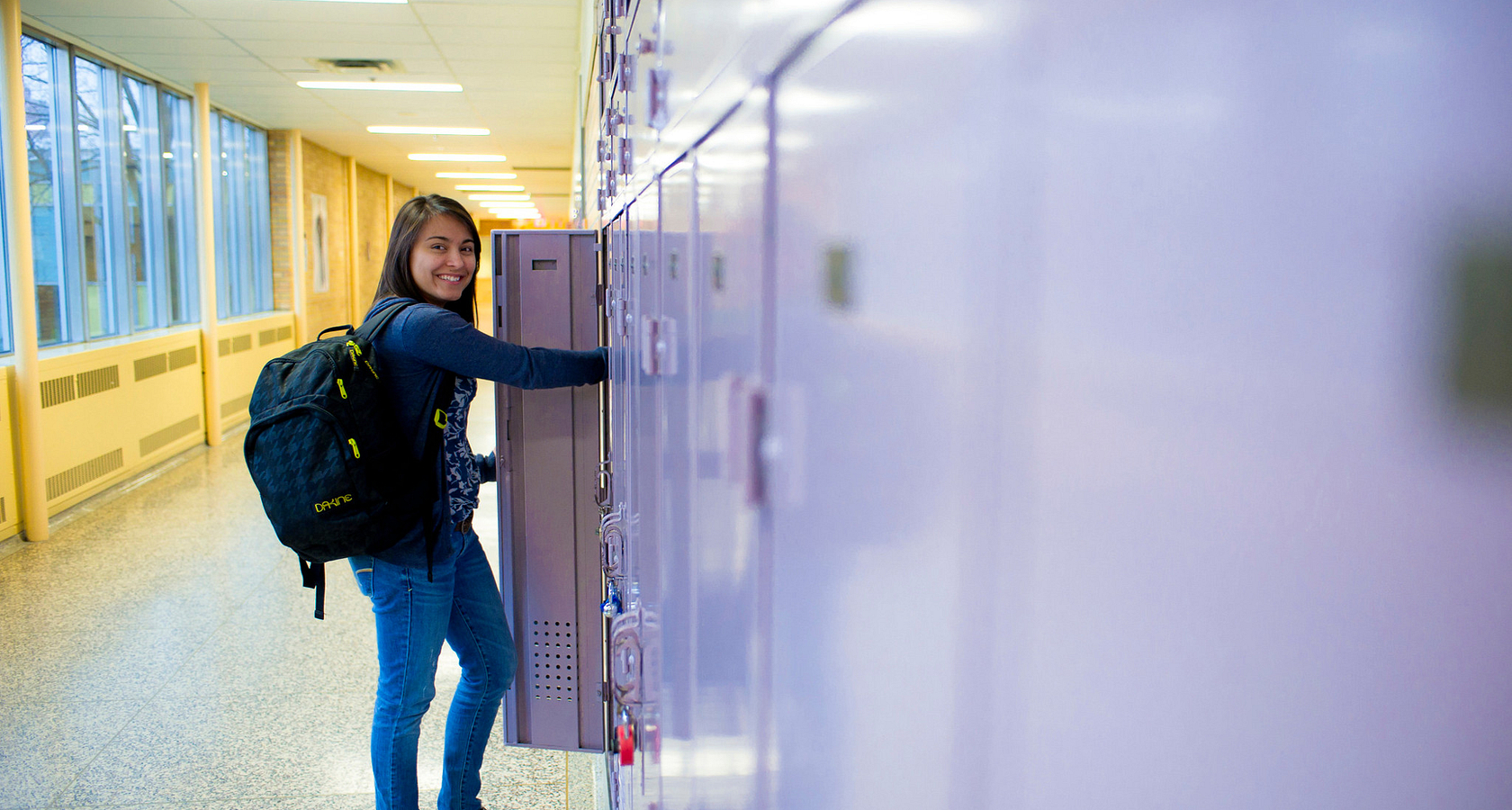 centennial college student smiling while opening their locker