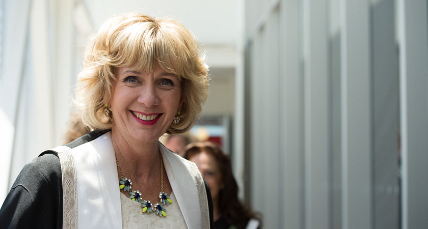 close up of centennial college president ann buller smiling at the entrance of a convocation ceremony