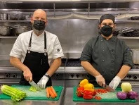 Abhishek Bakshi chopping vegetables in a kitchen