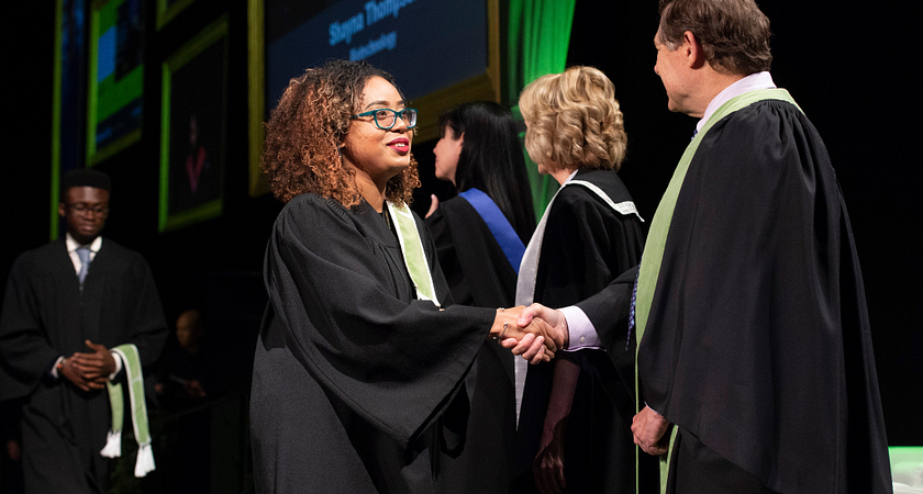 Students accepting their convocation award during their graduation ceremony at Centennial College