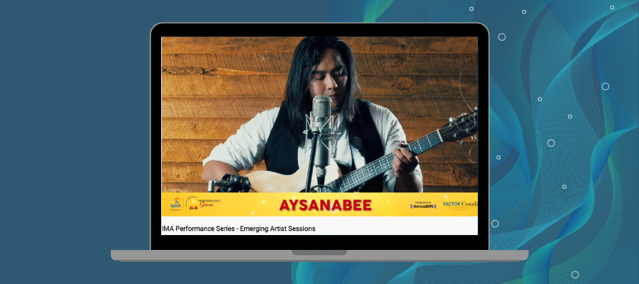 A picture of Evan Pang, known professionally as Aysanabee, performing with a guitar