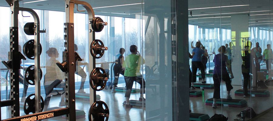 A few people working out at the gym for health and wellness