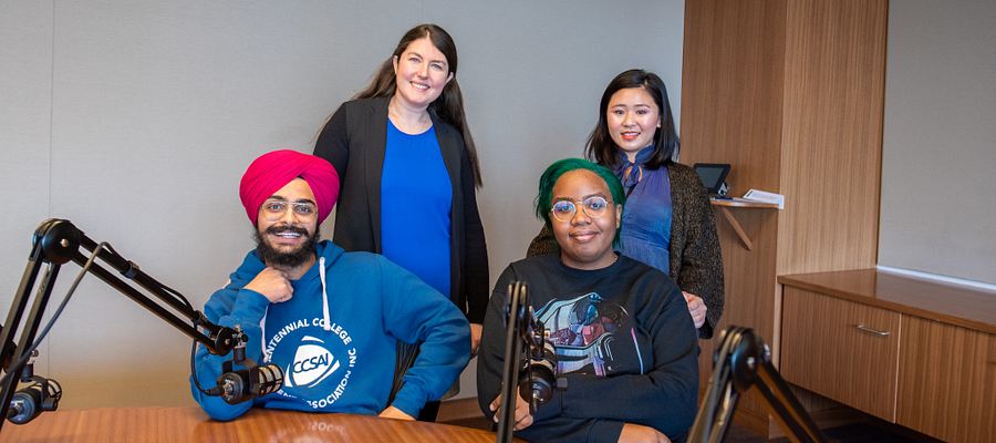 centennial college community members posing for a group photo before recording an episode of the centennial college podcast