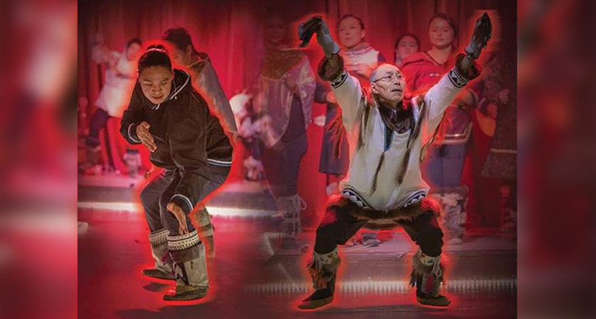 Members of the Inuit Drum ensemble, Arctic Song, wearing traditional Inuit clothing while dancing.