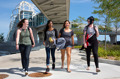 centennial college students smiling as they're walking into the pickering learning site