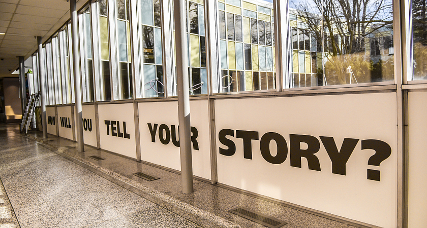 Picture of a hallway in the Story Arts Centre with the words How Will You Tell Your Story on a wall
