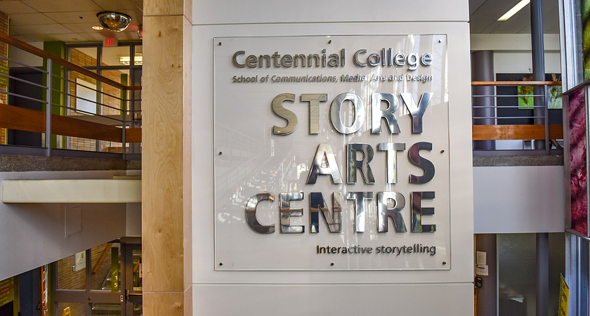 A sign on the wall displaying the words Story Arts Centre