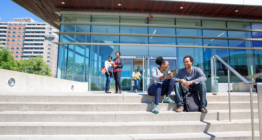 picture of Centennial College students sitting on the stairs outside of Morningside Campus
