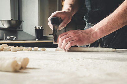 Chef cutting dough